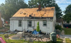 How Long Does a Roof Replacement Take - Roof replacement project showing workers removing old roofing materials
